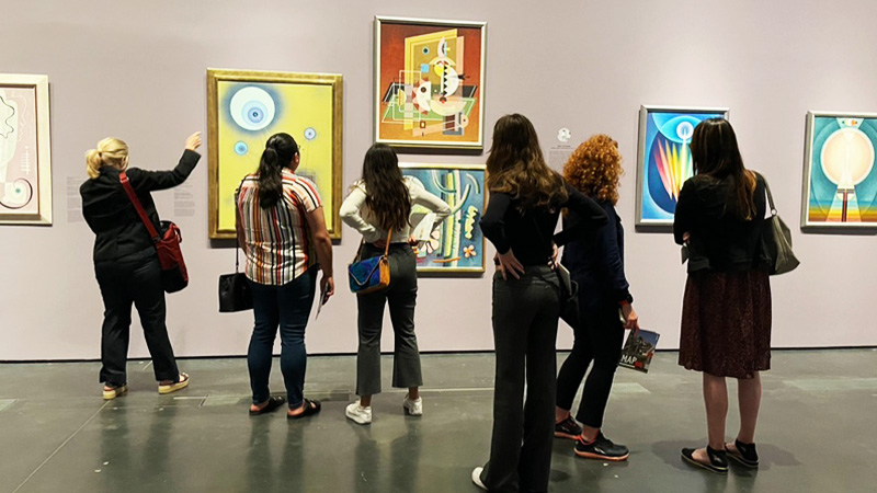 students and faculty view  art on an art history field trip