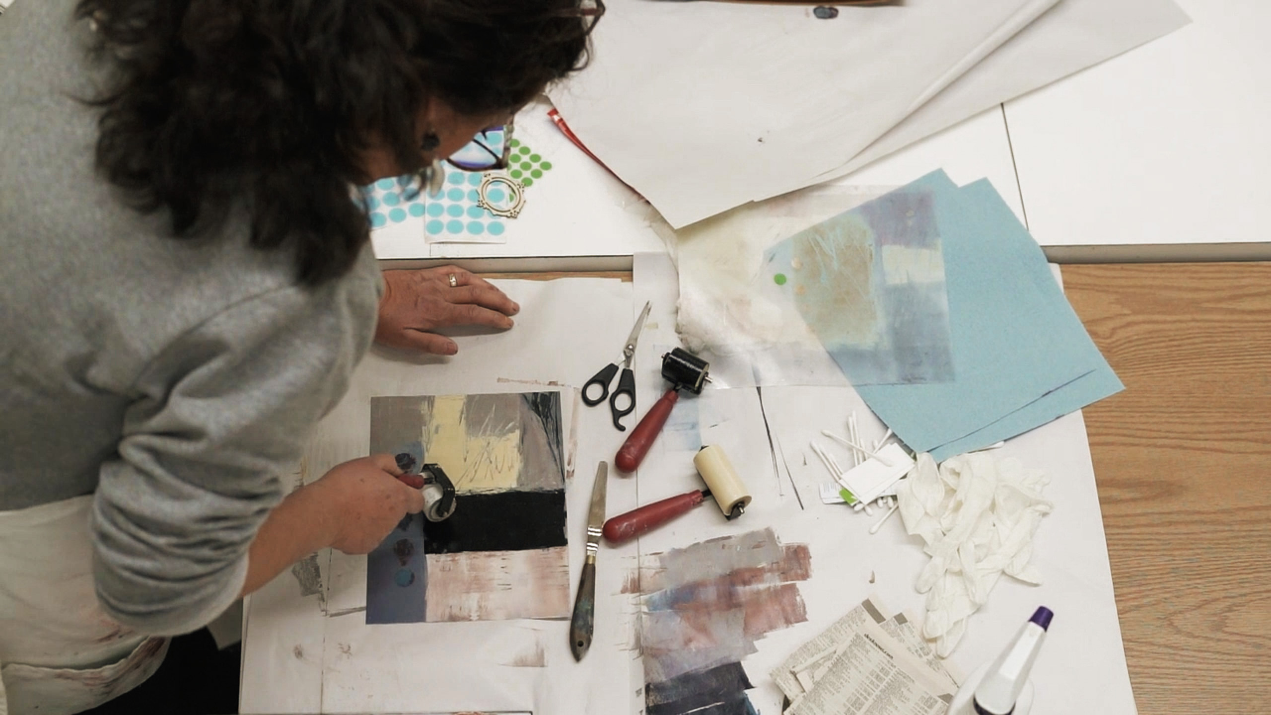 an artist working with mixed media materials