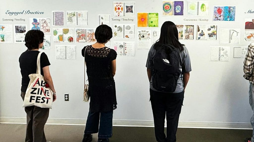 people looking at a wall of art