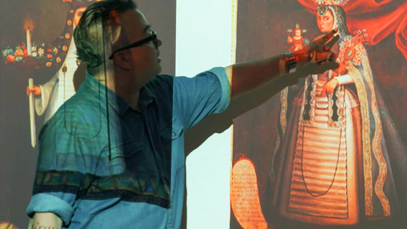 an art history professor pointing to a work during a lecture